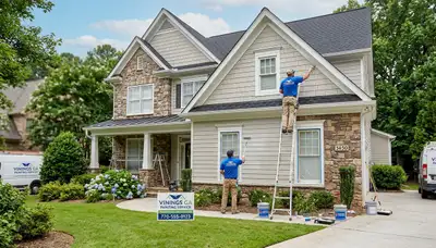 Professional house painters working on residential exterior in Marietta GA