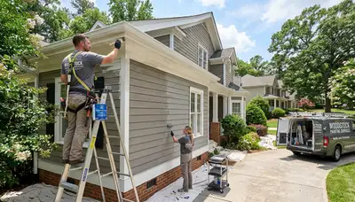 Professional house painters in Marietta GA applying fresh exterior paint to a suburban home
