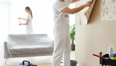 Professional wallpaper removal service by house painters in Marietta, GA preparing walls for paint